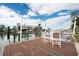 Private boat dock featuring a table with chairs and boat lifts for easy waterfront access at 538 Crystal Dr, Madeira Beach, FL 33708