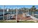 Private boat dock featuring a table with chairs and a boat lift for convenient waterfront access at 538 Crystal Dr, Madeira Beach, FL 33708