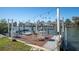 Private boat dock featuring a table with chairs and a boat lift for convenient waterfront access at 538 Crystal Dr, Madeira Beach, FL 33708