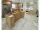Kitchen featuring new cabinets, stainless steel refrigerator, new flooring, and island at 538 Crystal Dr, Madeira Beach, FL 33708