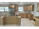 Spacious kitchen featuring new cabinets, stainless steel refrigerator, and marble floors at 538 Crystal Dr, Madeira Beach, FL 33708