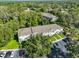 Aerial view of a multi-Gathering complex with a well-maintained lawn and parking area, surrounded by lush trees at 5717 Fishhawk Ridge Dr, Lithia, FL 33547