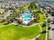 Attractive aerial view of a community pool, playground, and vast green lawns amid well-manicured landscaping at 5717 Fishhawk Ridge Dr, Lithia, FL 33547