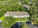 Aerial view of a multi-Gathering complex with a well-maintained lawn and parking area, surrounded by lush trees at 5717 Fishhawk Ridge Dr, Lithia, FL 33547