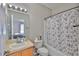 Cozy bathroom featuring a vanity, toilet, and shower with a vibrant shower curtain at 5717 Fishhawk Ridge Dr, Lithia, FL 33547