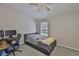 This bedroom features a ceiling fan, neutral-colored walls, and a comfortable double bed with a window at 5717 Fishhawk Ridge Dr, Lithia, FL 33547