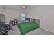 Bedroom with large ceiling fan and two beds beneath a window that provides plenty of sunlight at 5717 Fishhawk Ridge Dr, Lithia, FL 33547