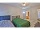 Spacious bedroom with a large ceiling fan and two beds next to a private bath at 5717 Fishhawk Ridge Dr, Lithia, FL 33547
