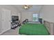 Bedroom with large ceiling fan, work desk, and two beds beneath a window at 5717 Fishhawk Ridge Dr, Lithia, FL 33547