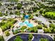 Stunning aerial view of a resort-style community pool featuring a large freeform design and lush tropical landscaping at 5717 Fishhawk Ridge Dr, Lithia, FL 33547