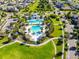 Beautiful aerial view of a community pool, playground, and surrounding green space, a Gathering-friendly oasis at 5717 Fishhawk Ridge Dr, Lithia, FL 33547