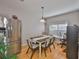 Dining room with stainless steel refrigerator, hardwood floors and natural light at 5717 Fishhawk Ridge Dr, Lithia, FL 33547