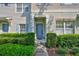 Charming townhome with light blue front door and well-maintained landscaping at 5717 Fishhawk Ridge Dr, Lithia, FL 33547