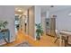 Open hallway leading to the kitchen with stainless steel refrigerator and dining area at 5717 Fishhawk Ridge Dr, Lithia, FL 33547