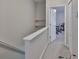 Upstairs hallway featuring shelves, a carpeted floor, and an open doorway to a room at 5717 Fishhawk Ridge Dr, Lithia, FL 33547