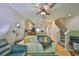 Open-concept living room with modern lighting, hardwood floors, and staircase access at 5717 Fishhawk Ridge Dr, Lithia, FL 33547