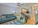 Bright living room with hardwood floors, a ceiling fan, and access to kitchen at 5717 Fishhawk Ridge Dr, Lithia, FL 33547
