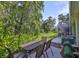 Relaxing outdoor patio area with table, chairs, and lush landscaping views at 5717 Fishhawk Ridge Dr, Lithia, FL 33547