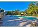 Beautiful community pool area with ample seating and mature landscaping under blue skies at 5717 Fishhawk Ridge Dr, Lithia, FL 33547