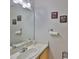 This powder room features neutral colors and a decorative framed art on the wall at 5717 Fishhawk Ridge Dr, Lithia, FL 33547