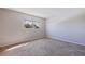Bedroom with neutral walls and plush carpeting, bathed in sunlight from the window at 5725 80Th N St # 301, St Petersburg, FL 33709