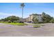 Condo complex with a manicured lawn, mature trees, and convenient parking at 5725 80Th N St # 301, St Petersburg, FL 33709