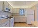 Well-maintained kitchen offers white appliances, ample countertop space, and convenient tiled flooring at 5725 80Th N St # 301, St Petersburg, FL 33709