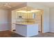 Bright eat-in kitchen with white cabinets, appliances, an island and recessed lighting at 5725 80Th N St # 301, St Petersburg, FL 33709
