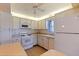 Functional kitchen features white cabinetry, appliances, tiled floor and plenty of counter space at 5725 80Th N St # 301, St Petersburg, FL 33709