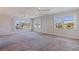 Spacious living room featuring neutral walls, carpet, and large windows offering ample natural light at 5725 80Th N St # 301, St Petersburg, FL 33709