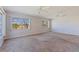 Neutral living room offers a spacious area with ample natural light from multiple windows at 5725 80Th N St # 301, St Petersburg, FL 33709