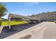 Exterior view of condo building with covered parking and green space at 5725 80Th N St # 301, St Petersburg, FL 33709
