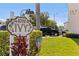 Close up shot of community sign, flowers, and building exterior at 5725 80Th N St # 301, St Petersburg, FL 33709