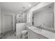 Modern bathroom showcasing a glass-enclosed shower, marble floors, and a stylish vanity at 5884 51St S St, St Petersburg, FL 33715
