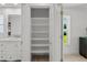 Bathroom linen closet featuring convenient built-in shelving, next to vanity at 5884 51St S St, St Petersburg, FL 33715