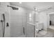 Modern bathroom featuring sleek glass shower, rain head, and marbled floors, with a bright vanity at 5884 51St S St, St Petersburg, FL 33715