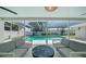 This covered patio showcases stylish outdoor furniture and a view of the sparkling pool and well-maintained yard at 5884 51St S St, St Petersburg, FL 33715