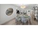View of a dining room showcasing an elegant table, chandelier, and open layout into the living area at 5884 51St S St, St Petersburg, FL 33715