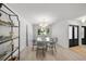 Elegant dining room with a round glass table, chandelier, and a view of the front yard at 5884 51St S St, St Petersburg, FL 33715