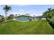 This expansive backyard boasts a lush lawn, mature trees, and complements the home's pristine exterior at 5884 51St S St, St Petersburg, FL 33715