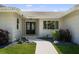 Elegant front entrance with modern double doors, complemented by tasteful landscaping and a stone pathway at 5884 51St S St, St Petersburg, FL 33715