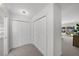 Hallway featuring multiple closets for storage, leading to the pool area with natural light at 5884 51St S St, St Petersburg, FL 33715
