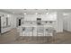Stylish kitchen featuring an island with seating, white cabinets, and modern appliances at 5884 51St S St, St Petersburg, FL 33715