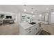 Open kitchen with an island, flowing into a living area and screened-in pool, all with lots of natural light at 5884 51St S St, St Petersburg, FL 33715