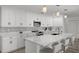 Bright, open kitchen with a large island, white cabinets, and stylish tile backsplash at 5884 51St S St, St Petersburg, FL 33715