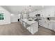 Spacious modern kitchen with a large island, white cabinetry, and stainless steel appliances at 5884 51St S St, St Petersburg, FL 33715
