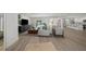 Bright and airy living room featuring hardwood floors and stylish furniture, flowing into the kitchen and pool area at 5884 51St S St, St Petersburg, FL 33715