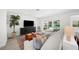Comfortable living room showcasing stylish decor, a large TV, and a view of the inviting pool area at 5884 51St S St, St Petersburg, FL 33715