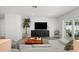 Inviting living room with a sleek entertainment center and view of the backyard pool, creating a relaxing ambiance at 5884 51St S St, St Petersburg, FL 33715