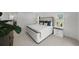 Bright main bedroom featuring a plush bed, side tables, and large windows with natural light at 5884 51St S St, St Petersburg, FL 33715